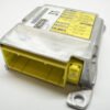 Toyota SRS airbag module top view showing yellow harness connector and multilingual SRS warning label