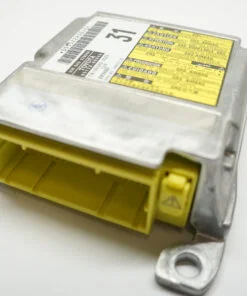 Toyota SRS airbag module top view showing yellow harness connector and multilingual SRS warning label
