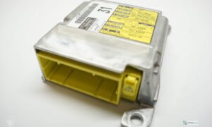 Toyota SRS airbag module top view showing yellow harness connector and multilingual SRS warning label